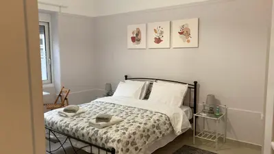 a bedroom with a bed with two towels on it at Chris AKROPOLI in Athens