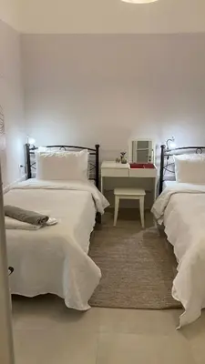 a bedroom with two beds and a table with a desk at Chris AKROPOLI in Athens