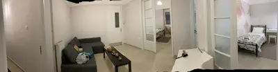 a living room with a couch and a bedroom at Chris AKROPOLI in Athens
