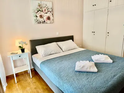 a bedroom with a bed with two white towels on it at Sun Beach Apartment in Anavissos