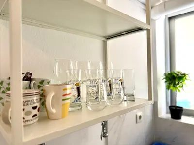 a shelf with glasses on it in a room at Sun Beach Apartment in Anavissos