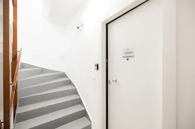 a stairwell with a glass door leading up to a staircase at Calliope Apartment in Athens