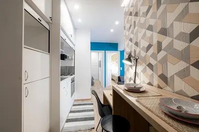a kitchen with a counter with a table with a lamp at Calliope Apartment in Athens