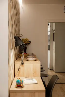 a room with a table with a lamp and chairs at Calliope Apartment in Athens