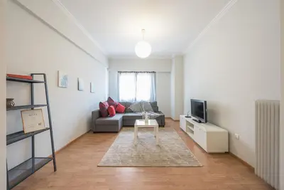 a living room with a couch and a tv at Pame Rentals - Entire Apartment with Free Parking in Athens
