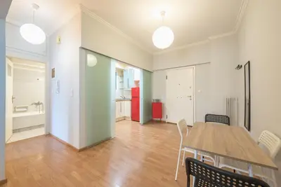 a room with a table and chairs and a kitchen at Pame Rentals - Entire Apartment with Free Parking in Athens