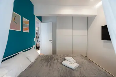 a bedroom with a bed with two towels on it at Aphrodite Apartment in Athens