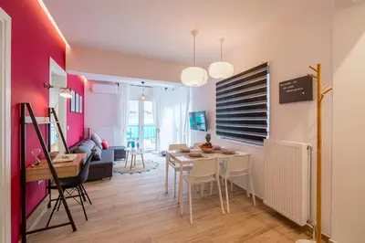 a living room with a table and a dining room at Aphrodite Apartment in Athens