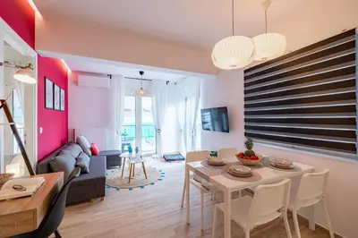 a living room with a table and a couch at Aphrodite Apartment in Athens