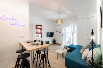 a living room with a blue couch and a table at Hestia Apartment in Athens