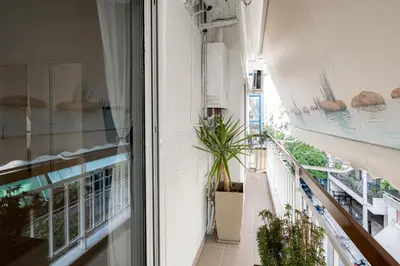 a balcony with plants and a view of a building at Hestia Apartment in Athens