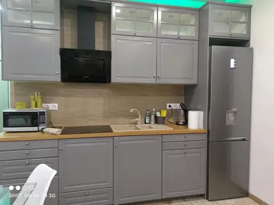 a kitchen with white cabinets and a stainless steel refrigerator at Lovely luxury apartment Sokratous 133, Kallithea in Athens