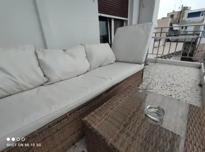 a couch sitting on top of a balcony at Lovely luxury apartment Sokratous 133, Kallithea in Athens