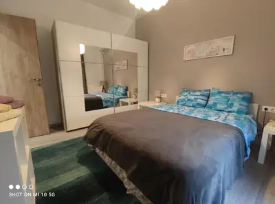a bedroom with a large bed and a large mirror at Lovely luxury apartment Sokratous 133, Kallithea in Athens