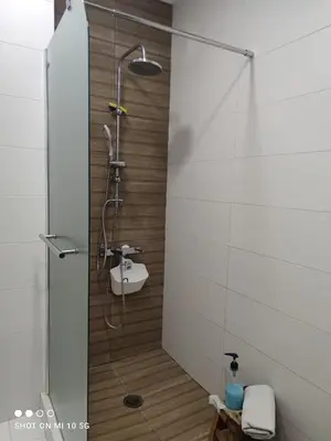 a shower with a glass door in a bathroom at Lovely luxury apartment Sokratous 133, Kallithea in Athens