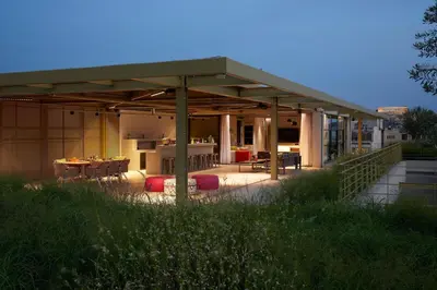 a building with a patio with a table and chairs at Moxy Athens City in Athens