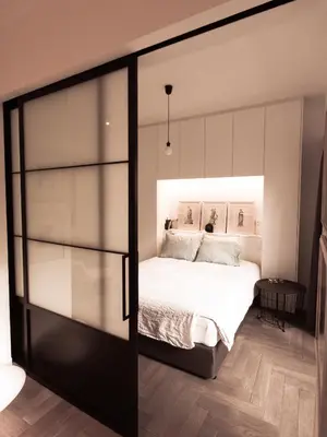 a bedroom with a bed and a sliding glass door at Vibrant Urban Chic Apartment in Athens