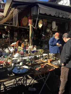 a group of people standing around a table in a market at Vibrant Urban Chic Apartment in Athens