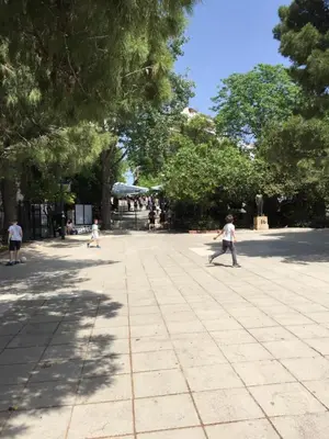 a group of children playing in a park at Vibrant Urban Chic Apartment in Athens