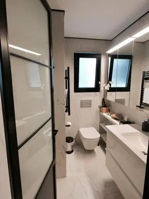 a bathroom with a toilet and a sink at Vibrant Urban Chic Apartment in Athens