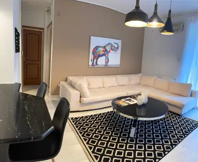 a living room with a couch and a table at Marble Athens Riviera in Athens