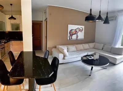 a living room with a couch and a table at Marble Athens Riviera in Athens
