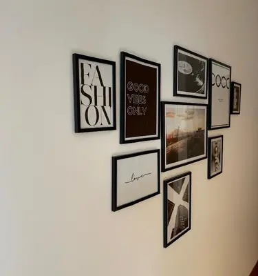 a group of framed pictures on a wall at Marble Athens Riviera in Athens