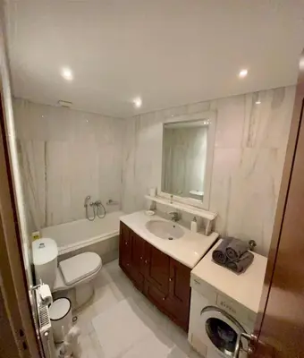 a bathroom with a sink and a toilet and a mirror at Marble Athens Riviera in Athens