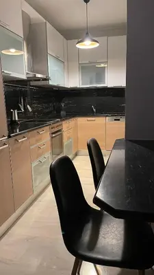 a kitchen with a black table and black chairs at Marble Athens Riviera in Athens