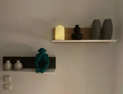 a shelf with vases and a green frog sitting on it at Marble Athens Riviera in Athens