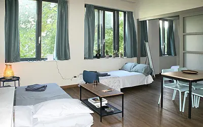 a living room with two beds and a table at Central studio in Monastiraki in Athens