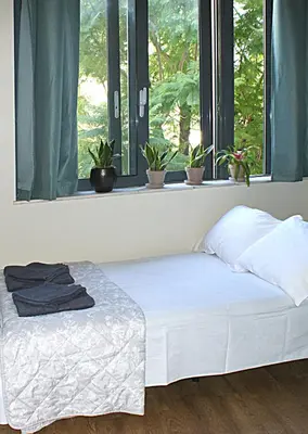 a bed sitting in a room with a window at Central studio in Monastiraki in Athens