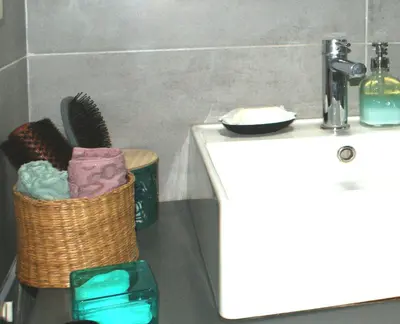 a bathroom with a basket of towels and a sink at Central studio in Monastiraki in Athens