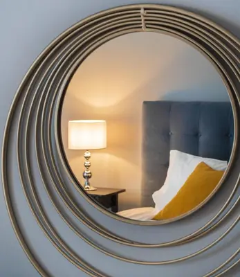 a mirror in a hotel room with a bed and a lamp at Alopekis in Athens