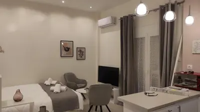 a bedroom with a bed and a desk and a chair at Irene's Beauty in Koukaki in Athens