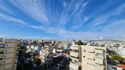 a view of a city with buildings and a blue sky at Xenophon Suite at National Opera SNFCC Park in Athens
