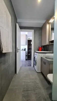 a kitchen with a washer and dryer in a room at Xenophon Suite at National Opera SNFCC Park in Athens