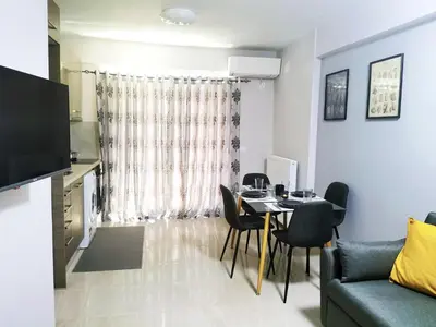 a living room with a table and a couch at 7-Athens new morden comfortable-center,metro,private parking in Athens