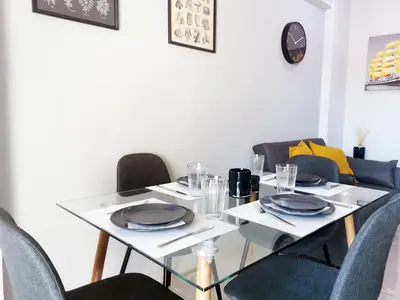a dining room with a white table and chairs at 7-Athens new morden comfortable-center,metro,private parking in Athens
