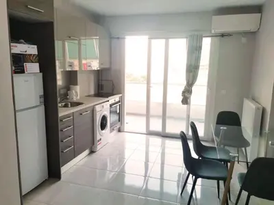a kitchen with a washer and dryer and a table and chairs at 7-Athens new morden comfortable-center,metro,private parking in Athens