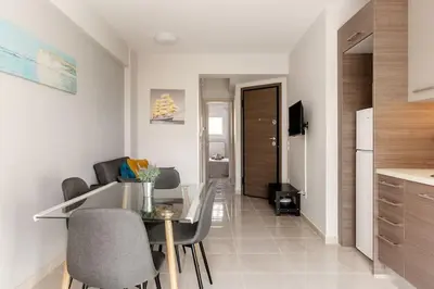 a kitchen and living room with a table and chairs at 7-Athens new morden comfortable-center,metro,private parking in Athens