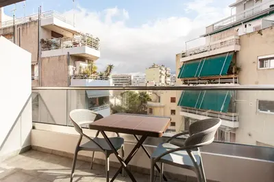 a table and chairs on a balcony with a view at 7-Athens new morden comfortable-center,metro,private parking in Athens