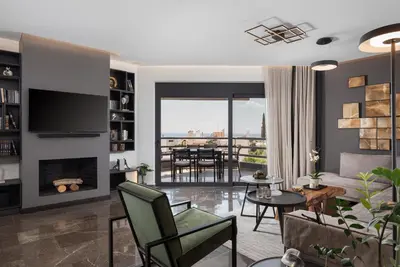 a living room with a couch and a fireplace at Athenian Riviera Luxurious Residence in Athens