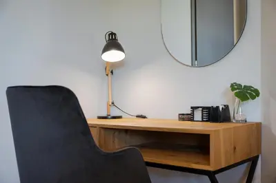 a desk with a chair and a lamp and a mirror at Athenian Riviera Luxurious Residence in Athens