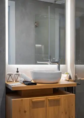 a bathroom with a white sink on a wooden counter at Athenian Riviera Luxurious Residence in Athens