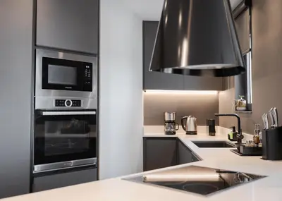 a kitchen with a stove top oven and a microwave at Athenian Riviera Luxurious Residence in Athens