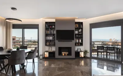 a living room with a fireplace and a dining room at Athenian Riviera Luxurious Residence in Athens