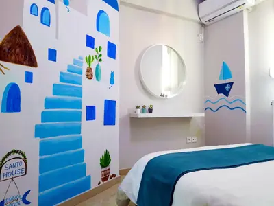 a bedroom with blue and white walls and a blue staircase at Santo House in Athens