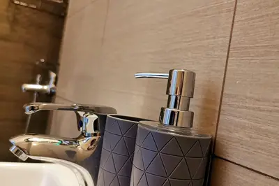 a bathroom sink with a faucet next to a sink at Santo House in Athens