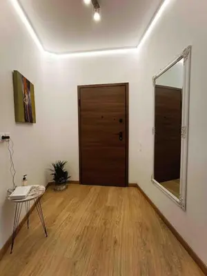 a room with a door and a table and a mirror at A.P Athens in Athens